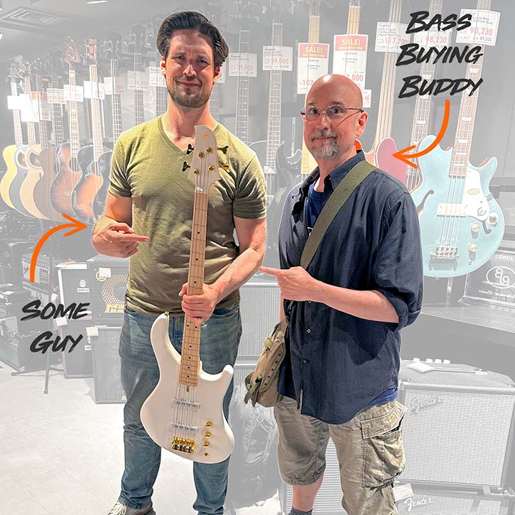 Picture of Josh next to his bass buying buddy in a bass store