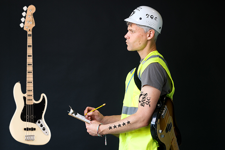 Gio dressed as a quality control worker inspecting a bass