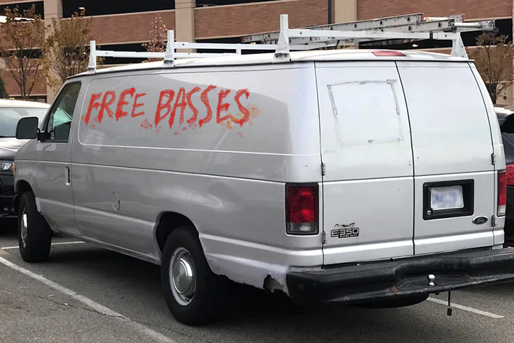 Picture of a creepy windowless van with words "Free Basses" scribbled on it in red