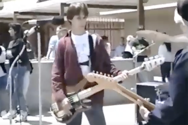 Screen capture of 1990 Green Day in High School show where Mike Dirnt is playing his Peavey Patriot