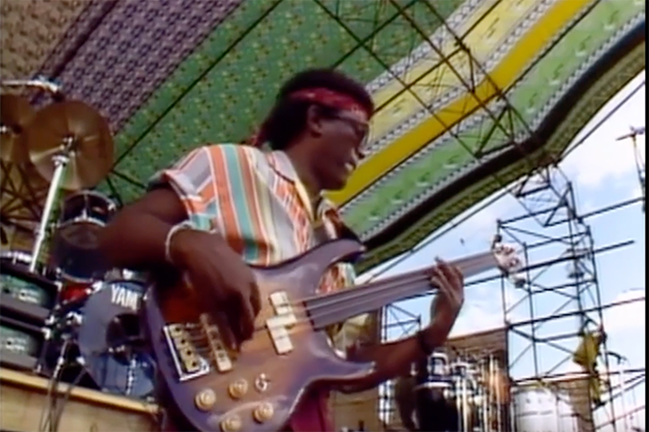 Screen capture of Bakithi Kumalo from 1987 where he’s playing his Washburn fretless