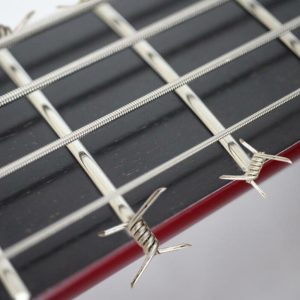 Picture of bass frets with spiky barbed wire-like ends