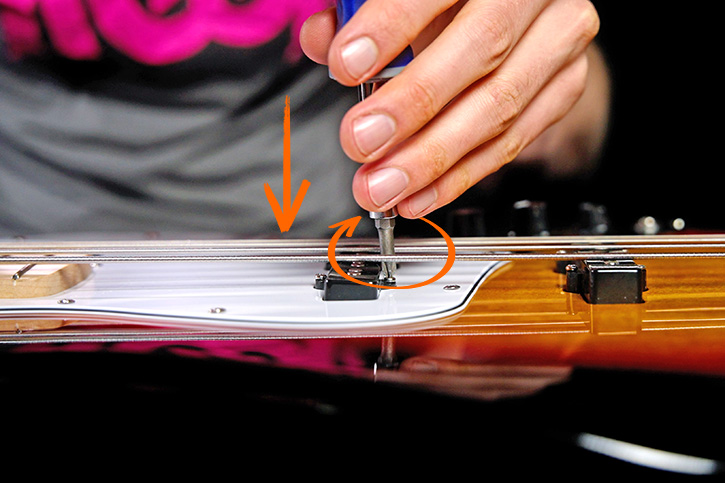 Picture showing how to tighten the screws to lower the pickups