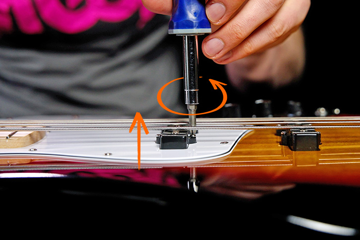 Picture showing how to loosen the screws to raise the pickups