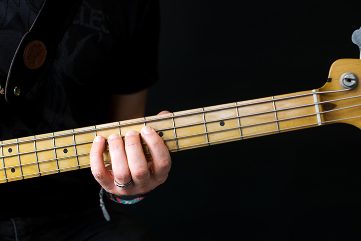 Image of a bassist's hand showing the Simandl technique