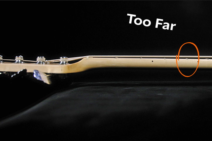 Picture showing strings too far away from the fret
