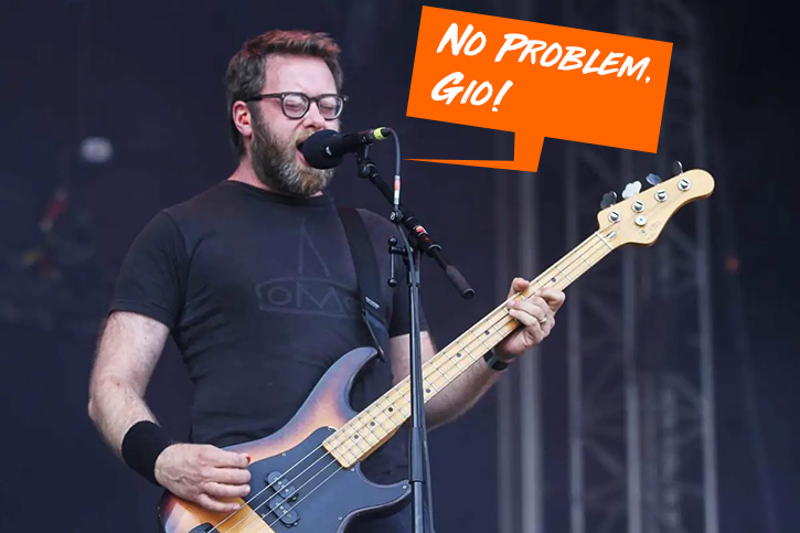 Picture of Aaron Beam singing on stage and playing the bass