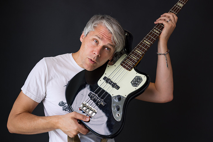 Picture of Gio holding a bass up to his ear